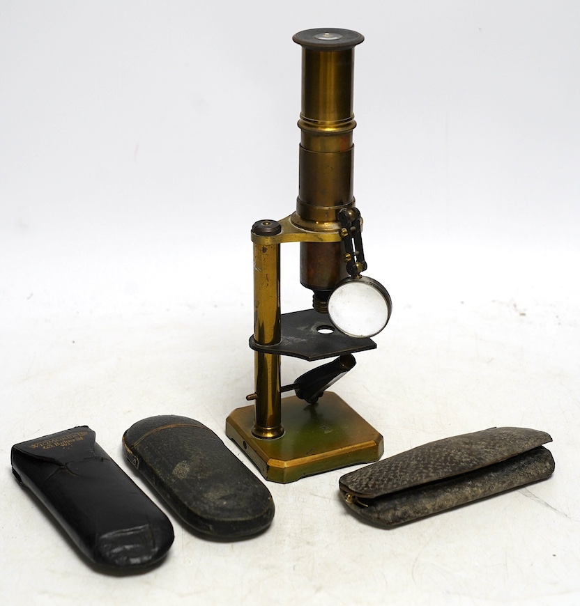 A late 19th century student’s field microscope, 22cm, and three pairs of early 20th century wire framed spectacles in contemporary cases. Condition - fair